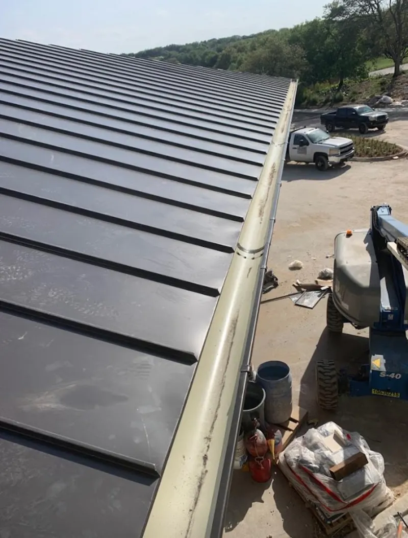 Standing seam panel and gutter detail on a metal roofing jobsite in New Hanover
